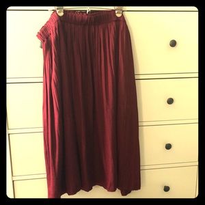 Long, wine colored, full, pleated skirt polyester